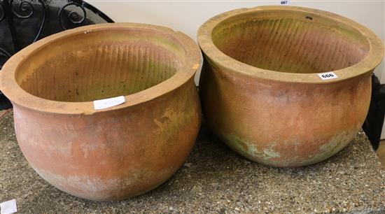 A pair of terracotta pots and four wall planters, W.40cm
